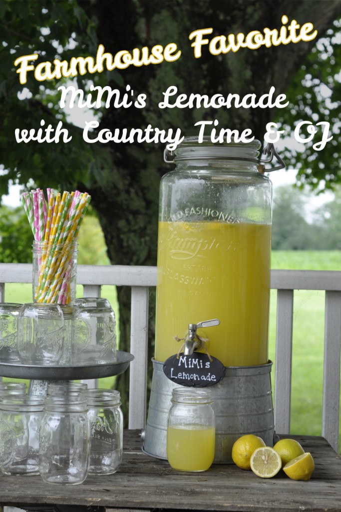 A rustic farmhouse-style lemonade station on a wooden porch featuring a large glass dispenser filled with MiMi’s Lemonade made from Country Time and orange juice. Surrounded by mason jars, striped paper straws, and fresh lemons, the setup evokes a cozy summer gathering in the country.