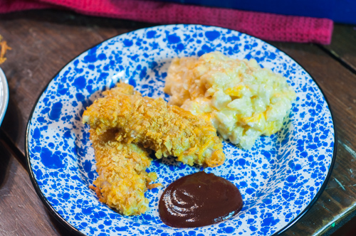 These Cheesy Chicken Tenders are a go to comfort food here! Moist with a cheesy crunchy cornflake coating!