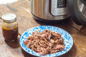 Shredded beef roast cooked from frozen in the Instant Pot with broth, ready for freezer meals or to serve.