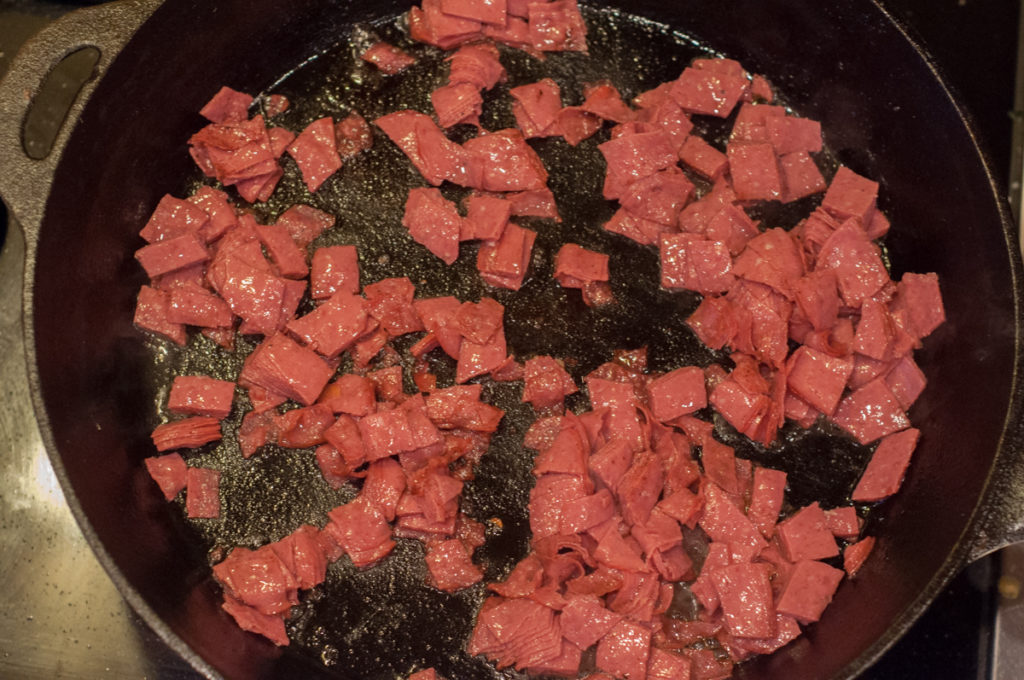 chopped dried beef browning in skillet for creamed chipped beef gravy