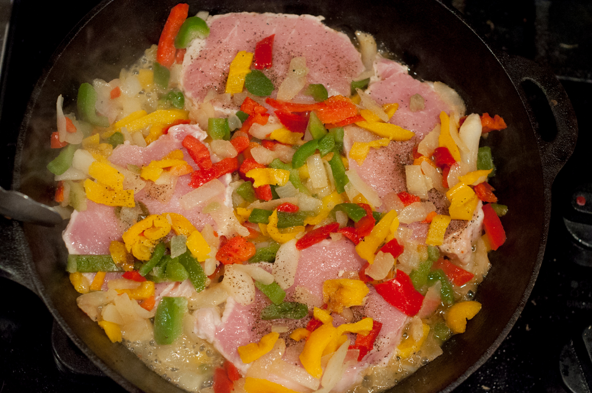 Easy Skillet Peppers, Onions and Pork Chops from Farmwife Feeds is an easy meal using frozen pepper and onion mix and boneless pork chops. #pork #recipe #porkchops