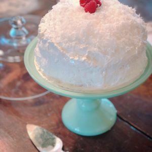 Coconut Icebox Cake from Farmwife Feeds -a traditional refrigerator cake and a poke cake all together that is better when you make it a day ahead. #coconut #cake #pokecake