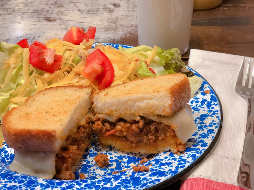 Super Easy Italian Sloppy Joes from Farmwife Feeds served on your favorite ready to go garlic bread and a side salad is a go to meal for busy days. #sloppyjoes #Italian #recipe #sandwich