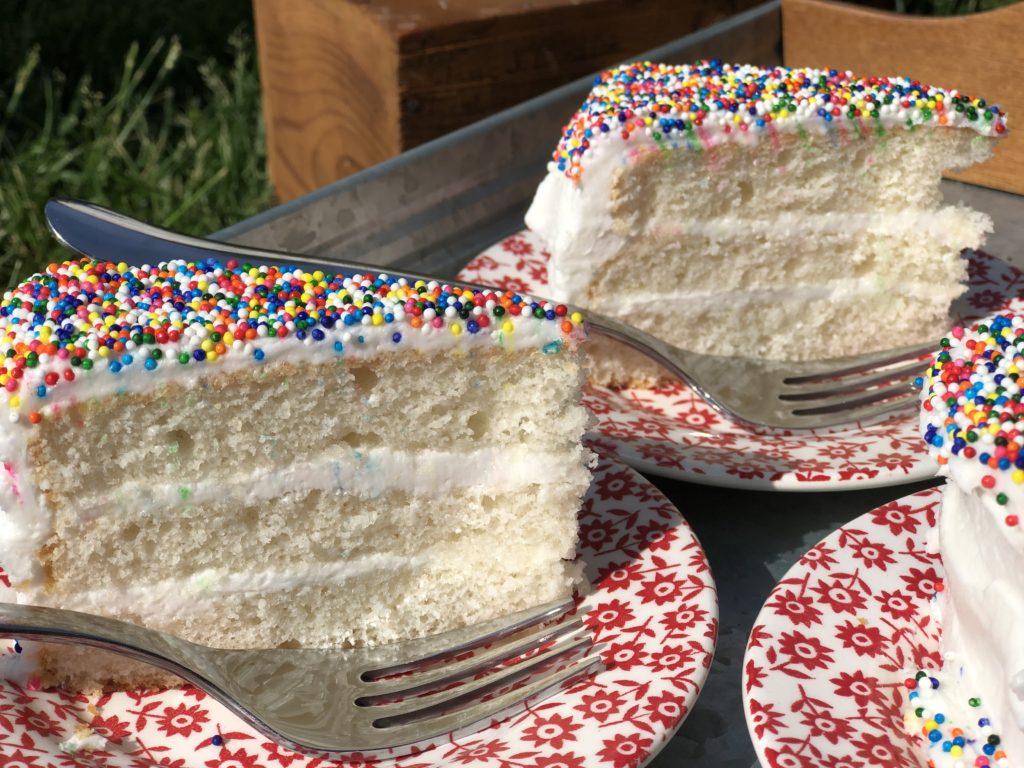 Everyday Wedding Cake from Farmwife Feeds is an easy homemade add to box mix cake that tastes bakery made. #weddingcake #cake #sprinkles #boxmix