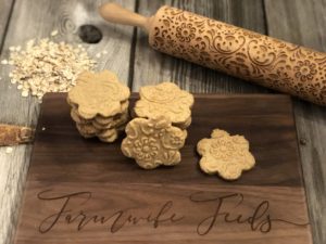 Gluten free shortbread cookies made with oat flour stacked on wooden board with rolling pin