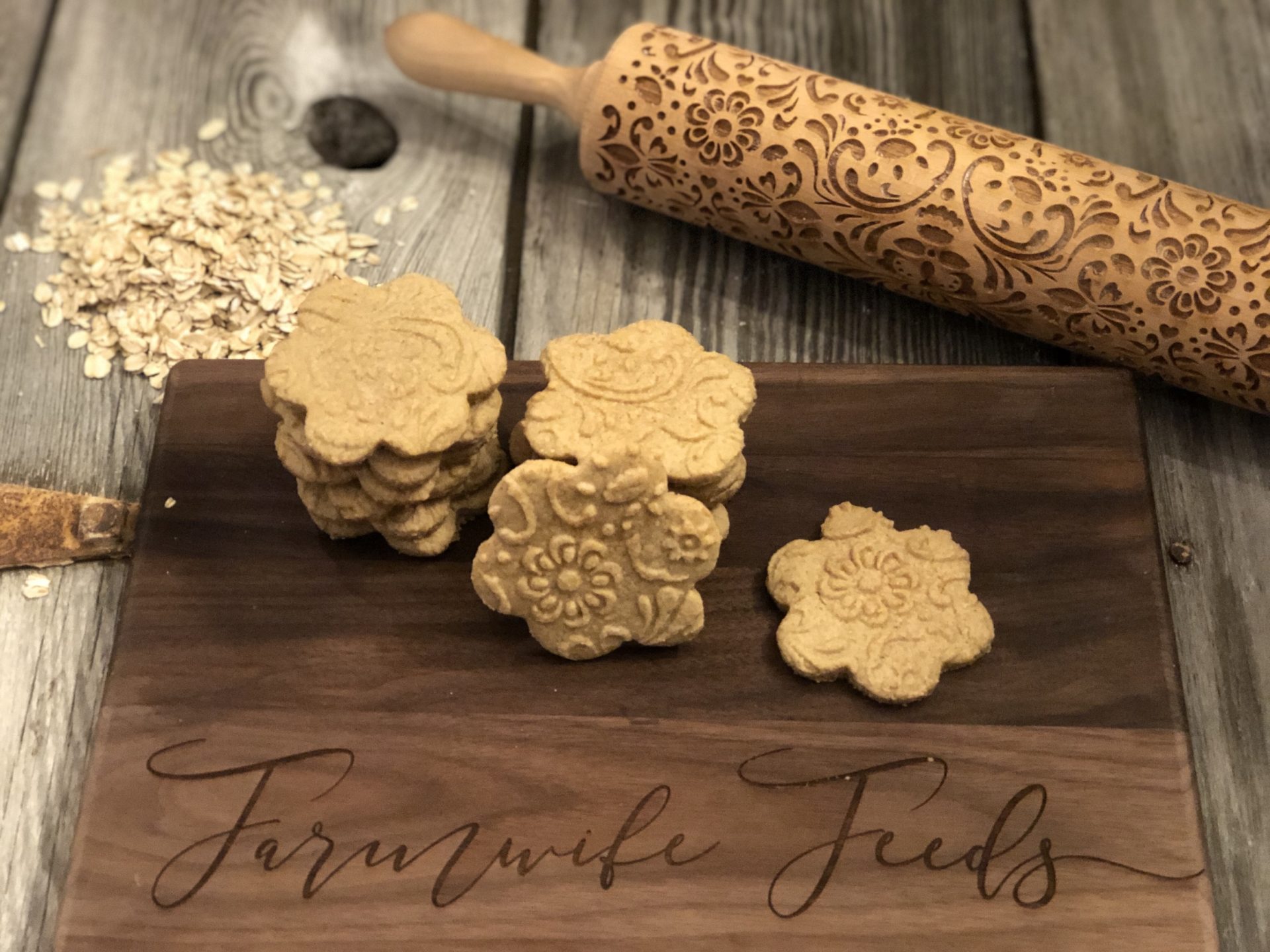 Gluten free shortbread cookies made with oat flour stacked on wooden board with rolling pin