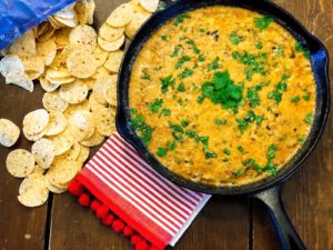 Taco Chili Cheese Dip from Farmwife Feeds makes a great appetizer or meal, is stovetop, oven and crockpot friendly. #dip #crockpot #cheese