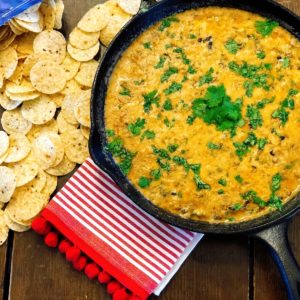 Taco Chili Cheese Dip from Farmwife Feeds makes a great appetizer or meal, is stovetop, oven and crockpot friendly. #dip #crockpot #cheese