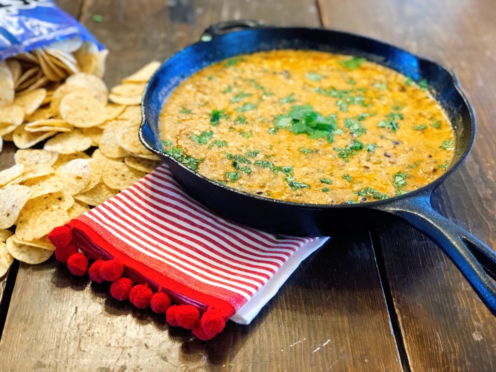 Taco Chili Cheese Dip from Farmwife Feeds makes a great appetizer or meal, is stovetop, oven and crockpot friendly. #dip #crockpot #cheese