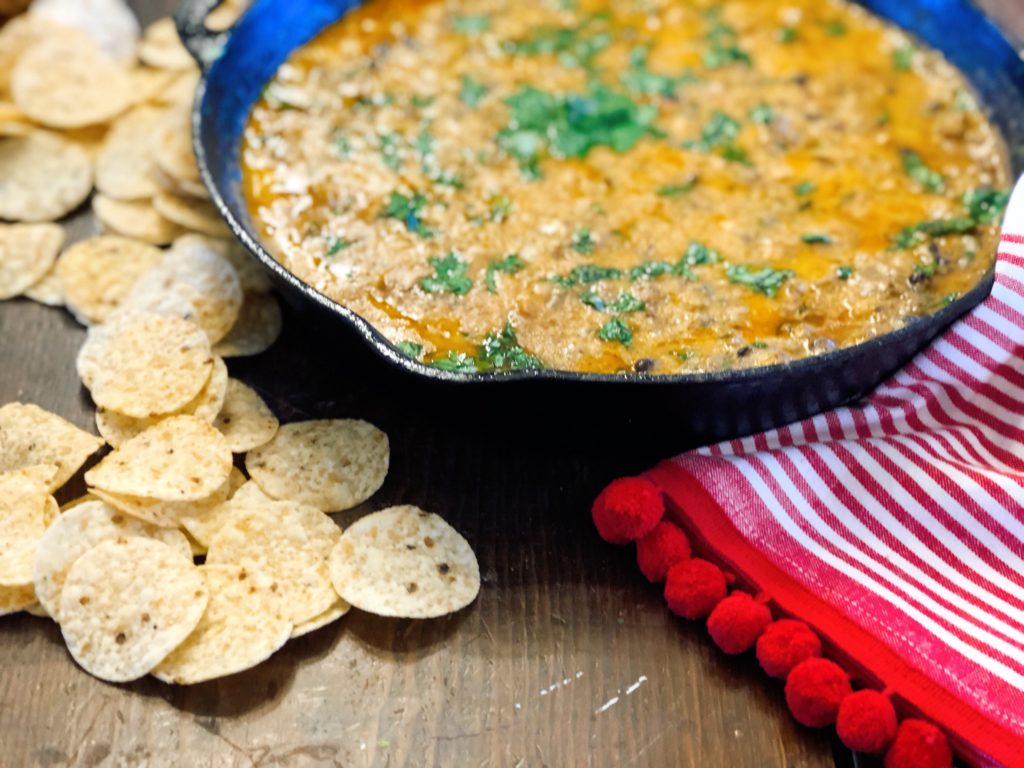 Taco Chili Cheese Dip from Farmwife Feeds makes a great appetizer or meal, is stovetop, oven and crockpot friendly. #dip #crockpot #cheese