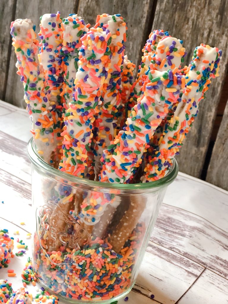 Funfetti White Chocolate Dipped Pretzels from Farmwife Feeds are full of sprinkle, white chocolate, cake mix and the saltiness of the pretzel for a fun snack or treat. #whitechocolate #sprinkles #saltysweet #pretzel #treat