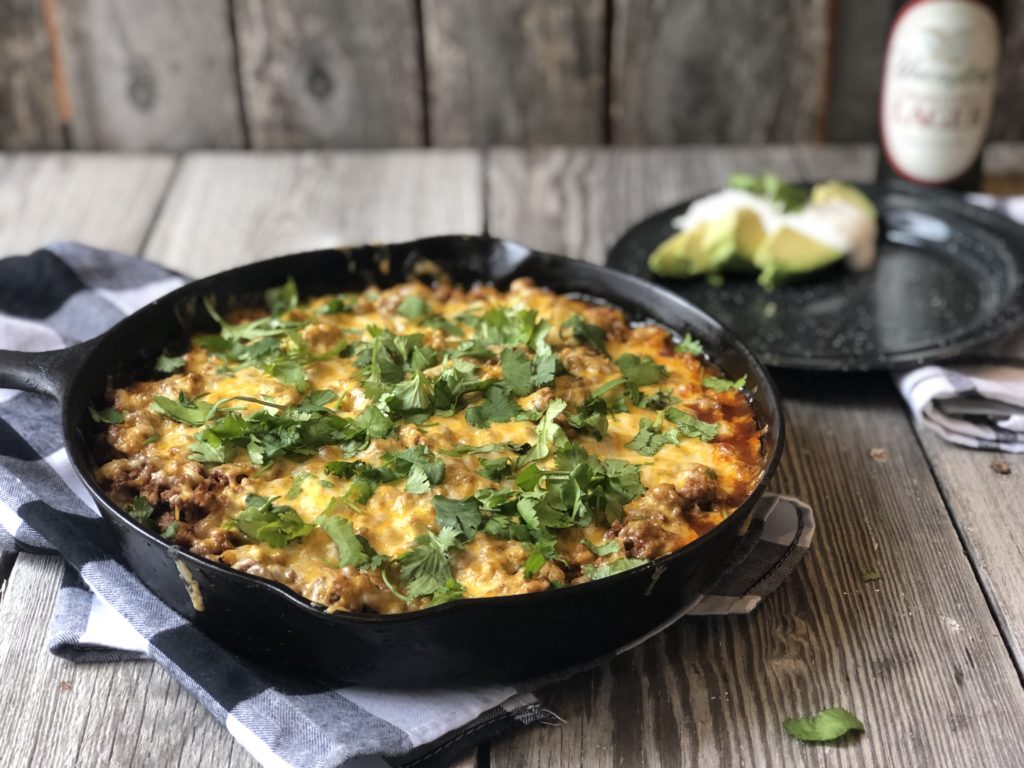 Tamale Pie from Farmwife Feeds made with easy homemade cornbread base, hamburger, enchilada sauce covered in cheese. #cornbread #beef #enchilada