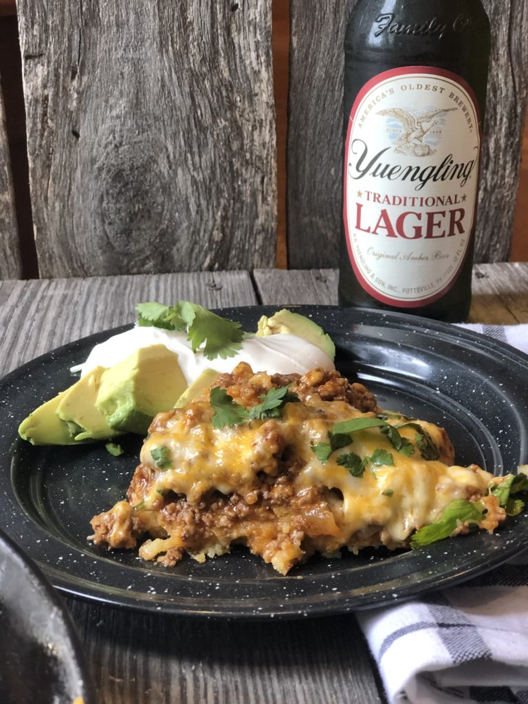 Tamale Pie from Farmwife Feeds made with easy homemade cornbread base, hamburger, enchilada sauce covered in cheese. #cornbread #beef #enchilada