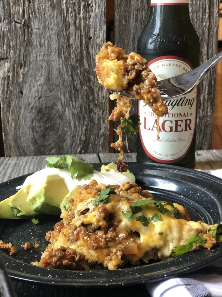 Tamale Pie from Farmwife Feeds made with easy homemade cornbread base, hamburger, enchilada sauce covered in cheese. #cornbread #beef #enchilada