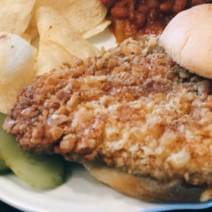 Breaded Pork Tenderloin from Farmwife Feeds is a crispy juicy classic sandwich with a cracker breading. #pork #sandwich #tenderloin