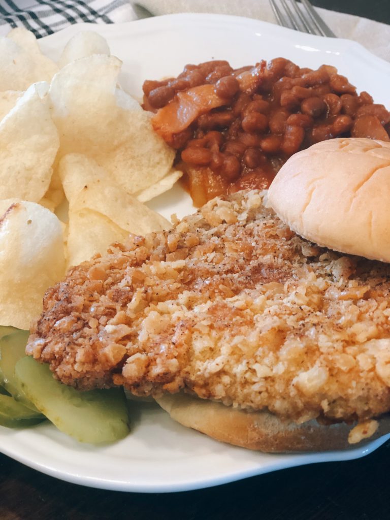 Breaded Pork Tenderloin from Farmwife Feeds is a crispy juicy classic sandwich with a cracker breading. #pork #sandwich #tenderloin