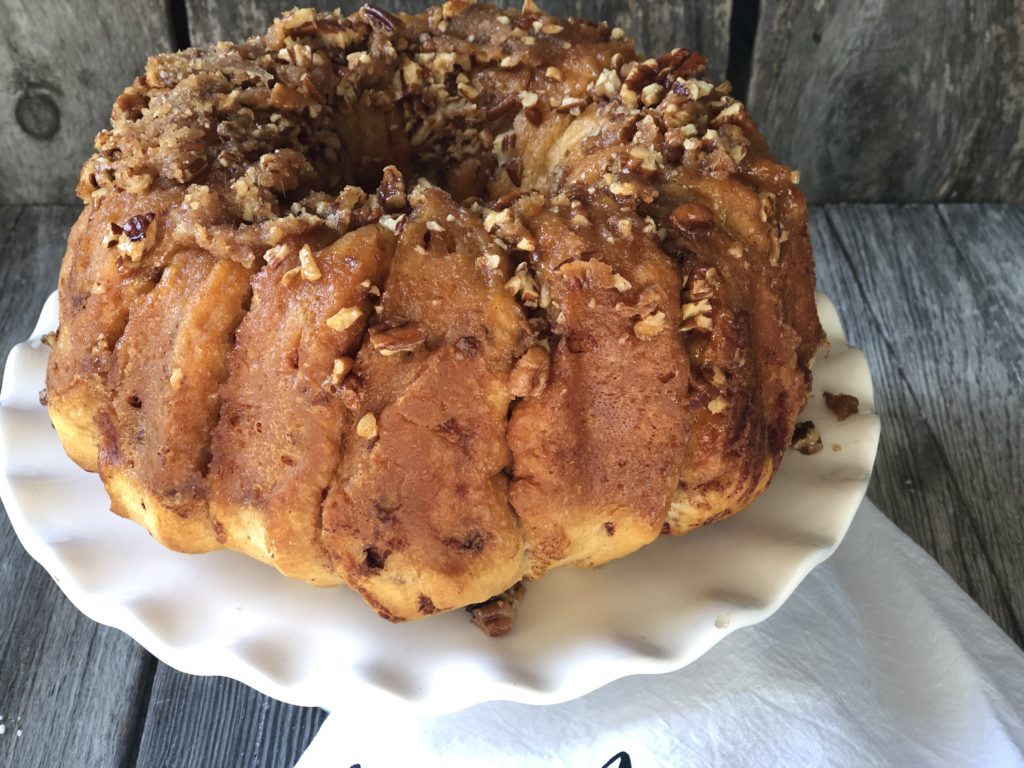 Easy Caramel Cinnamon Roll Bundt Cake from Farmwife Feeds makes a pop can of cinnamon rolls into a delicious easy bundt cake with a caramel glaze and pecans. #cinnamonrolls #bundtcake #easybreakfast 