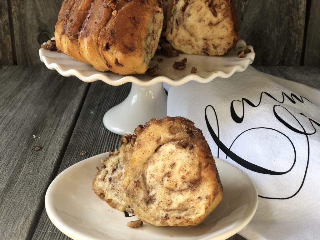 Easy Caramel Cinnamon Roll Bundt Cake from Farmwife Feeds makes a pop can of cinnamon rolls into a delicious easy bundt cake with a caramel glaze and pecans. #cinnamonrolls #bundtcake #easybreakfast