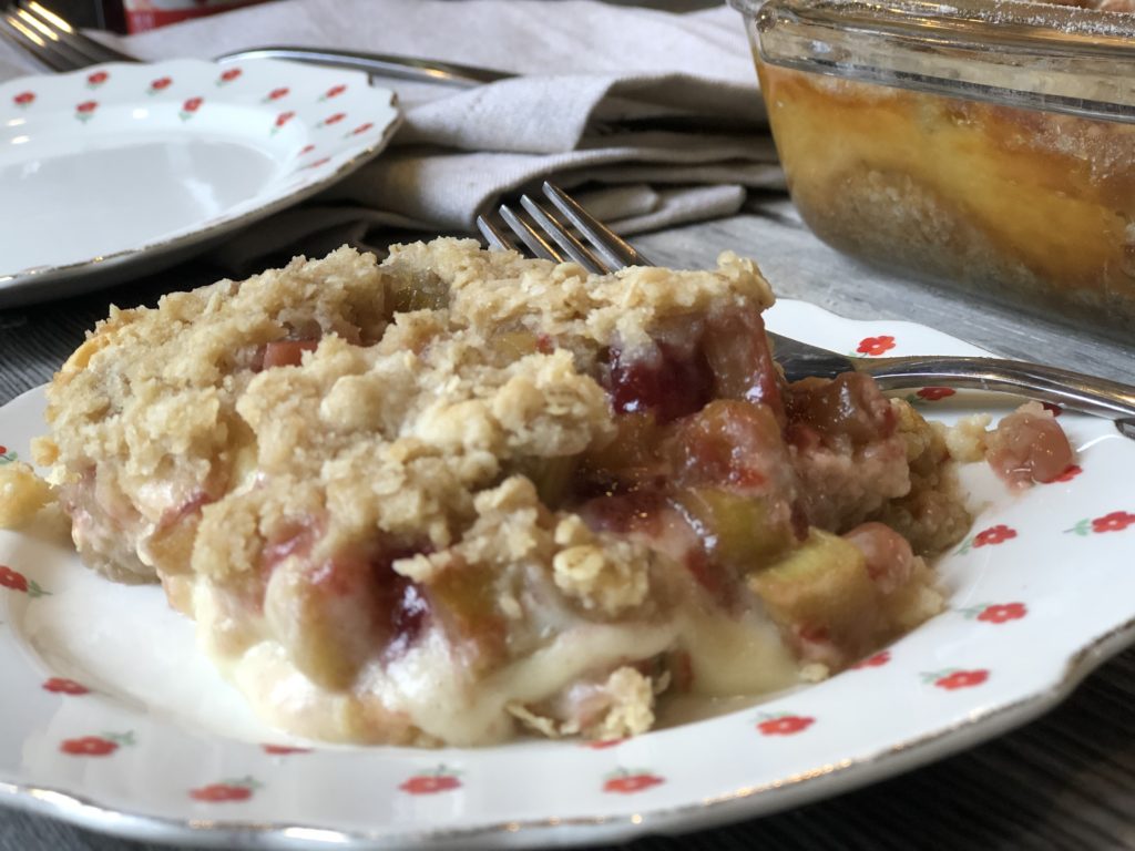 Strawberry Rhubarb Cheesecake Crisp from Farmwife Feeds is everything the name says all in one delicious dish. #crisp #strawberry #cheesecake #dessert #rhubarb