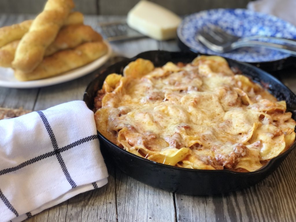 Easy Ravioli Casserole from Farmwife Feeds is a hearty meal that is ready in less than 30 minutes or can be prepped ahead for busy nights.