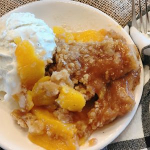 Spiced Rum Peach Crisp from Farmwife Feeds is the perfect fresh peach dessert with a spicy warmness that pairs perfect with ice cream. #peachcrisp #peaches #fruit