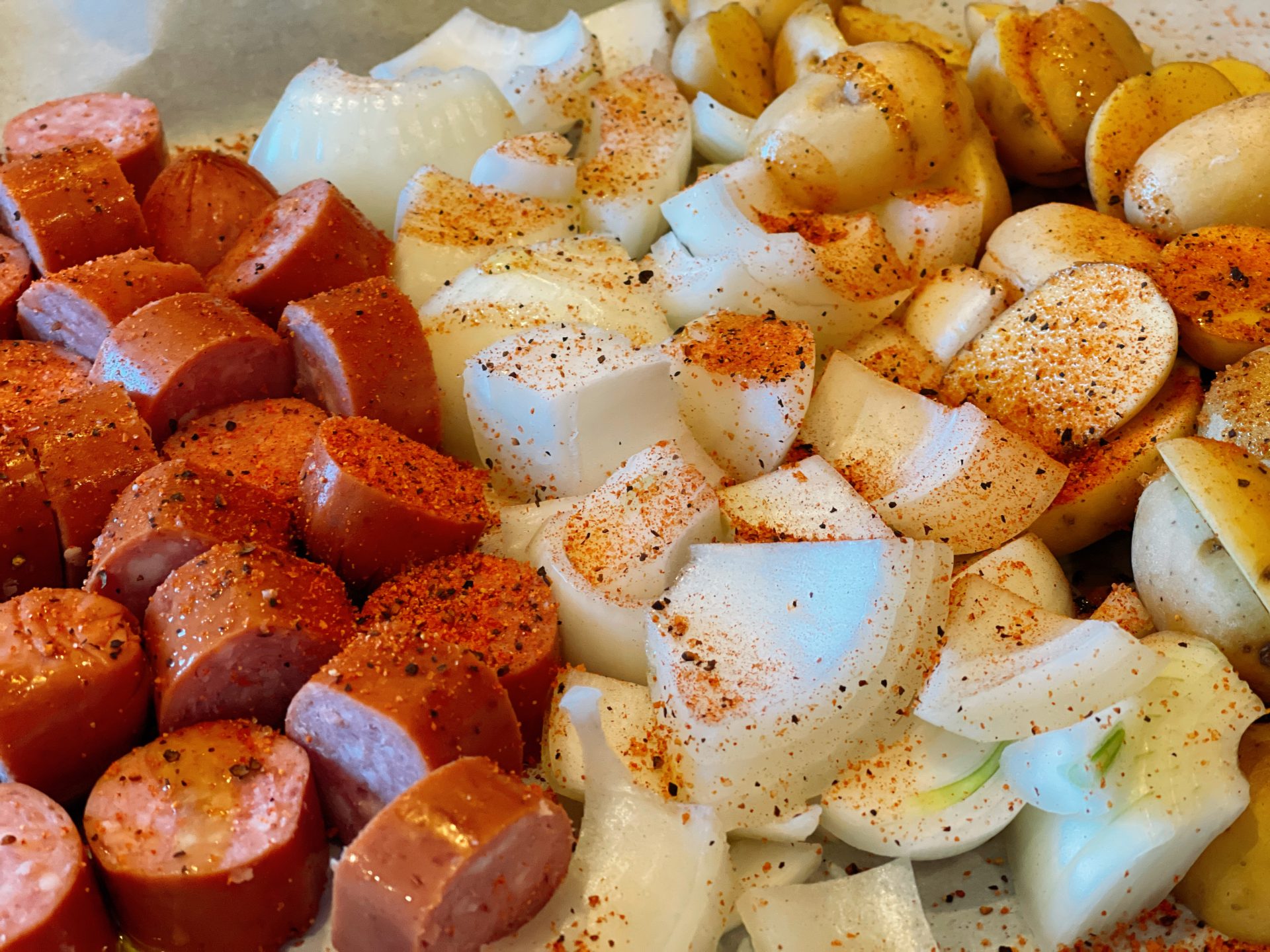 Oven Roasted Smoked Sausage and Potatoes from Farmwife Feeds, an easy sheet pan dinner on busy weeknights using your family favorite seasoning. #sheetpanmeal #onepan #smokedsausage