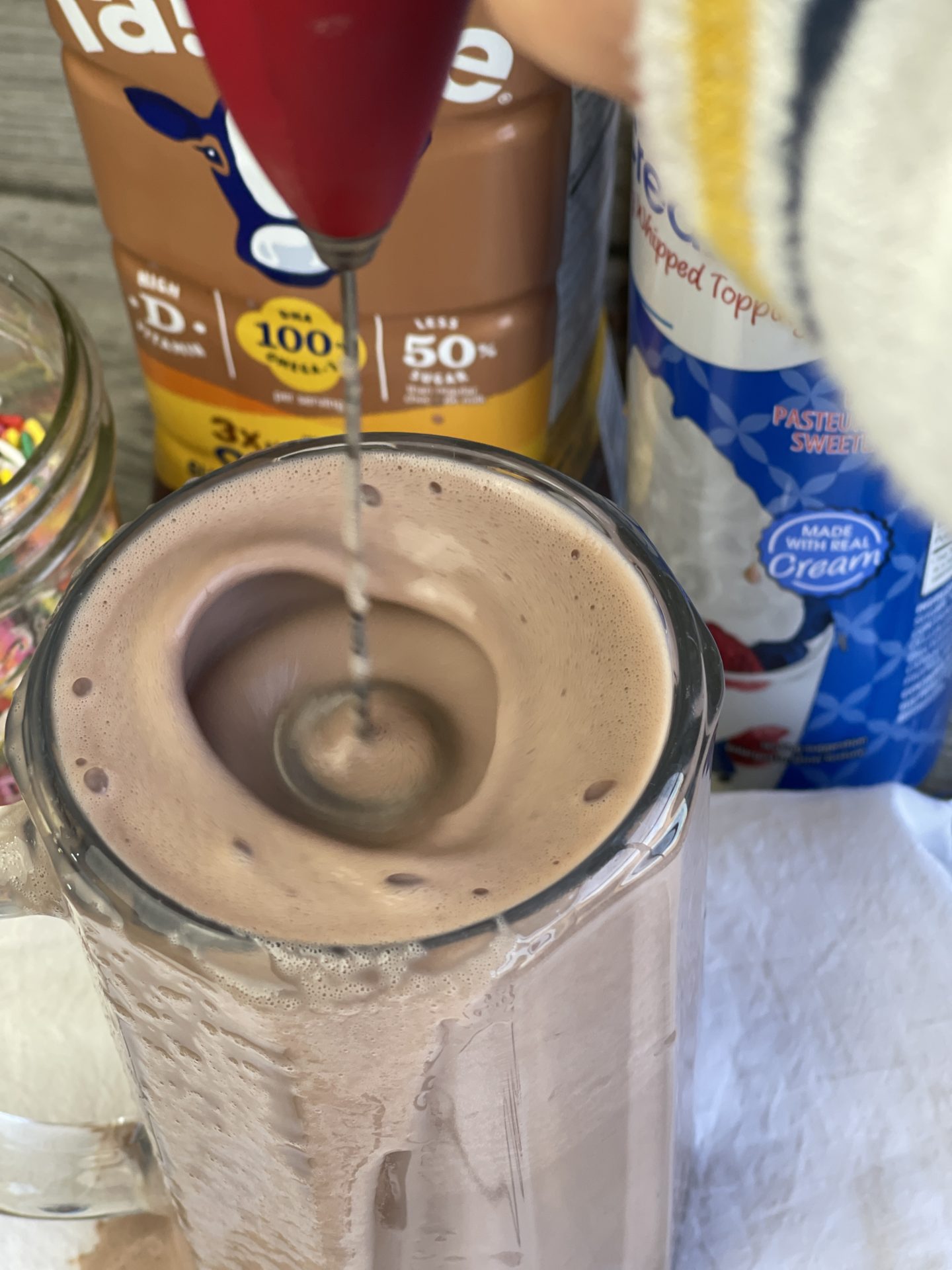 Cade's Perfect Chocolate Milk, Fairlife Chocolate Milk is frothed then topped with whipped cream and sprinkles. A sweet filling snack with a protein packed milk that is delicious and healthy. #milk #chocolate #fairlife
