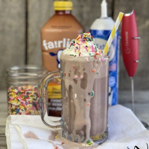 Cade's Perfect Chocolate Milk, Fairlife Chocolate Milk is frothed then topped with whipped cream and sprinkles. A sweet filling snack with a protein packed milk that is delicious and healthy. #milk #chocolate #fairlife