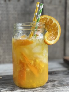 Glass of an Orange Shake-up with orange slice, crushed ice and straws