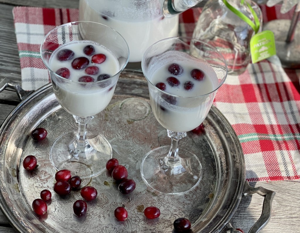 White Christmas Cocktail from Farmwife Feeds. A dreamy creamy coconut mixed drink that mixed by the pitcher for quiet nights or a holiday party. #holidaycocktail #coconut