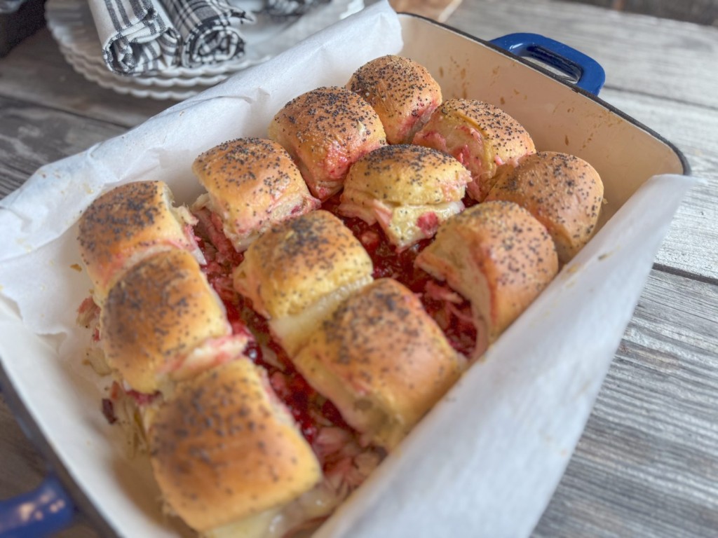 Turkey Cranberry Sliders in a dish with Hawaiian rolls, cranberry sauce, turkey, and cheese, topped with poppy seeds.