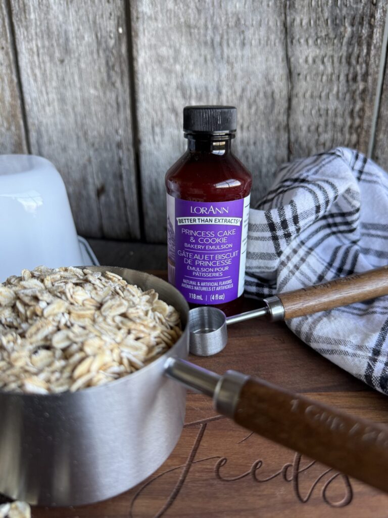 Bottle of Princess Cake and Cookie Emulsion used for baking gluten free cookies with oats and kitchen tools.